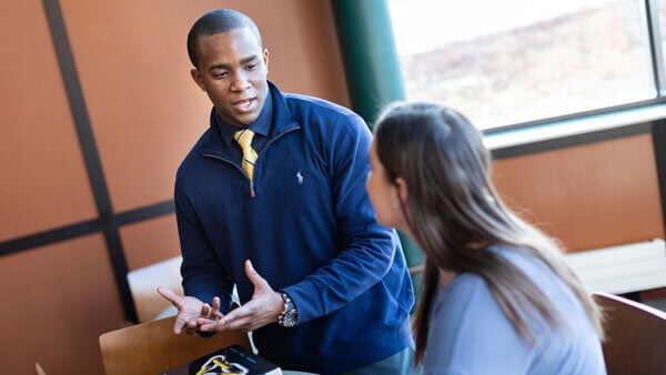 Two graduate students talk together on the North Haven Campus