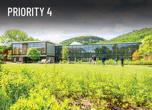 Students play games on the lawn outside the newly renovated Recreation and Wellness facility on a sunny day, priority 4